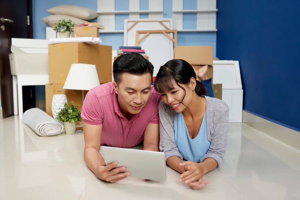 couple resting in their new hdb room discussing about their shopping plan