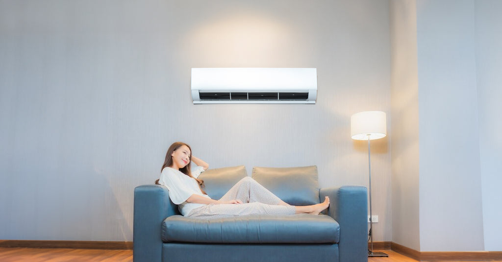 lady relaxing under the aircon in the living room