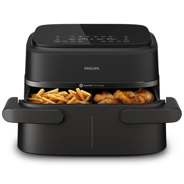 Philips air fryer with fries and chicken on a white background