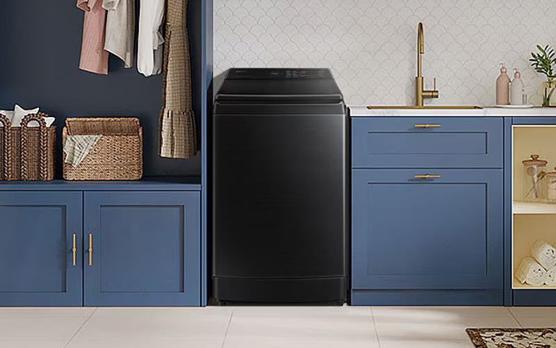 black samsung top load washer in a blue kitchen